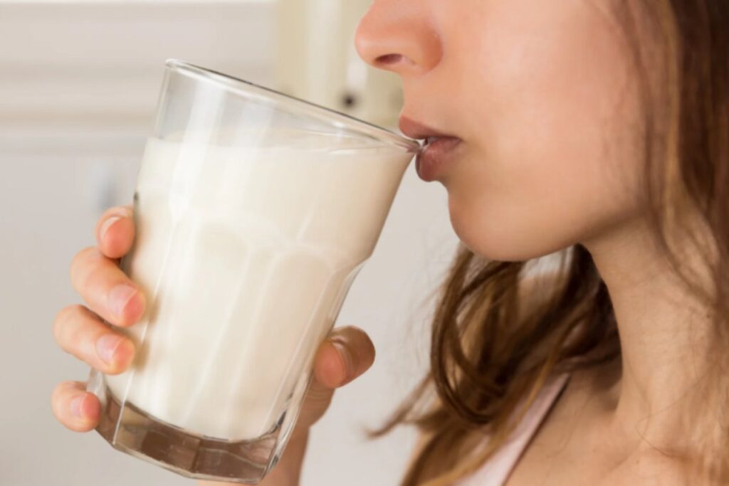 donna che beve un bicchiere di latte