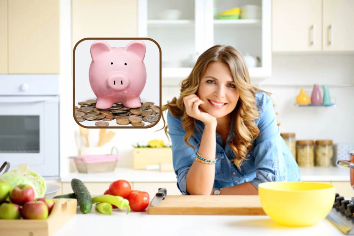 donna appoggiata sul mobile della cucina con accanto degli ortaggi
