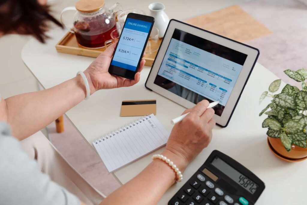 Donna con smartphone, tablet e calcolatrice